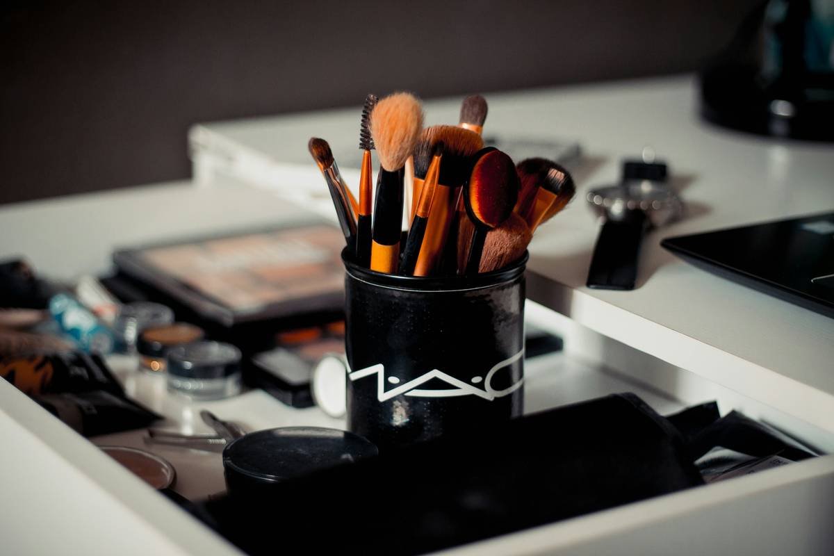Artist applying fantasy makeup using theatrical makeup brushes on model